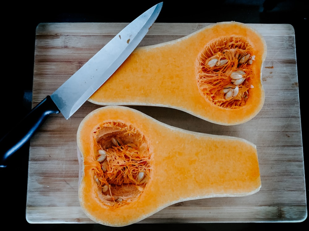 stainless steel knife on brown wooden chopping board