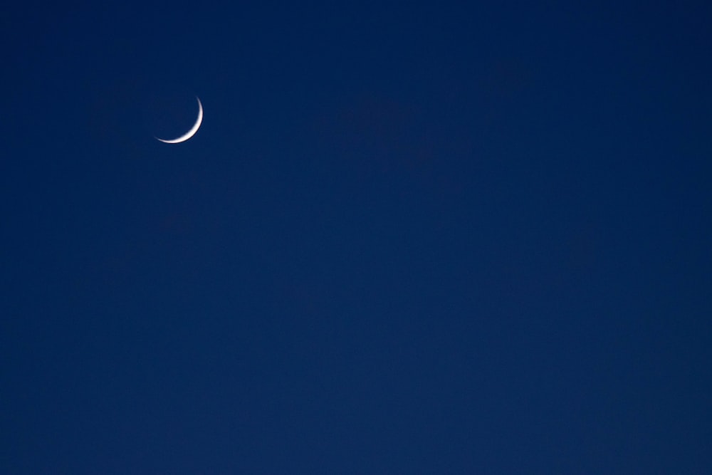 crescent moon in blue sky
