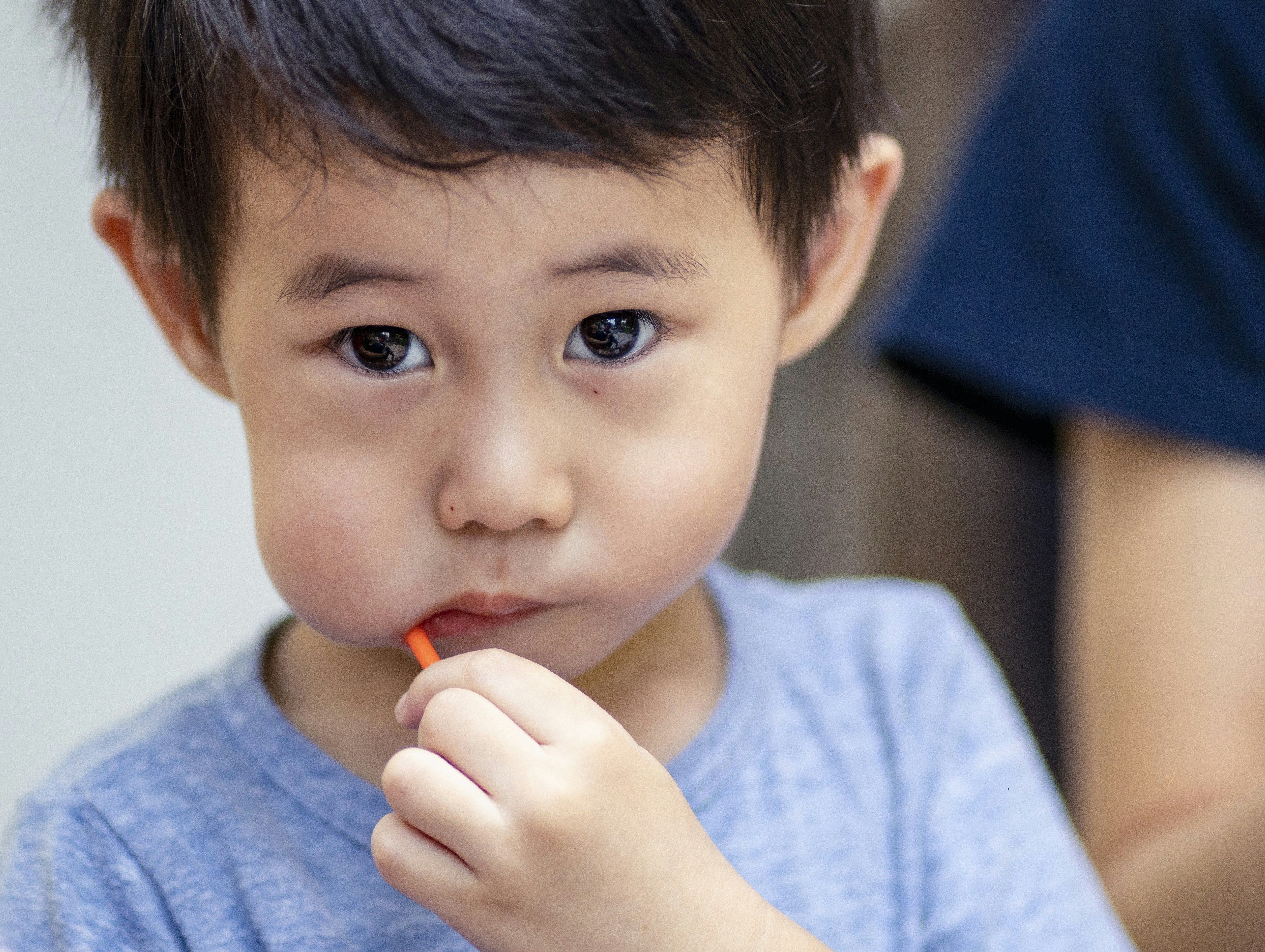 Happy child in blue shirt during nutrition consultation
