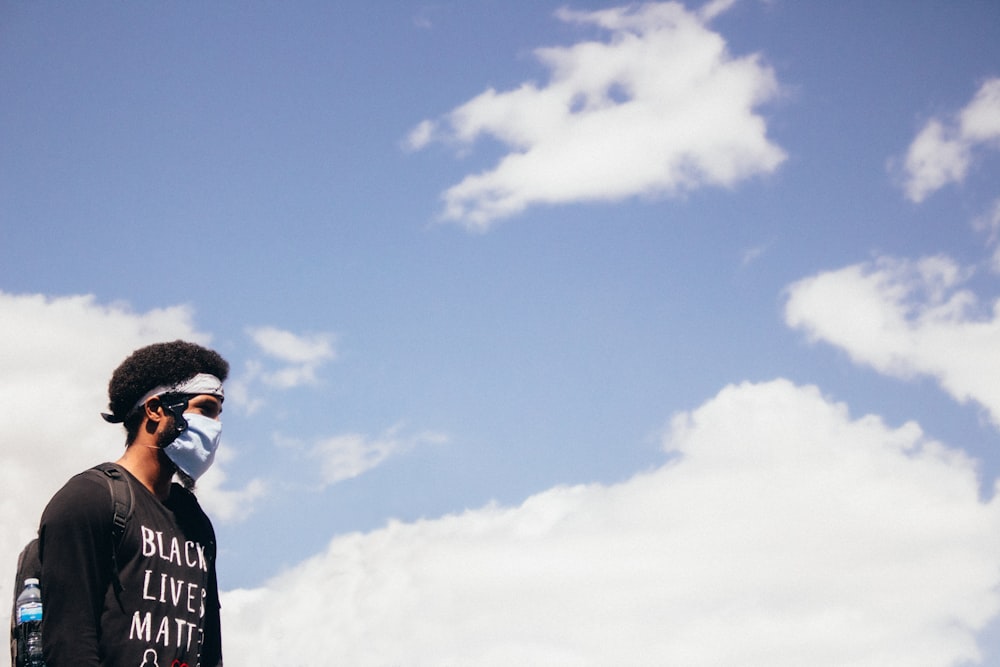 man in black and white shirt under blue sky during daytime