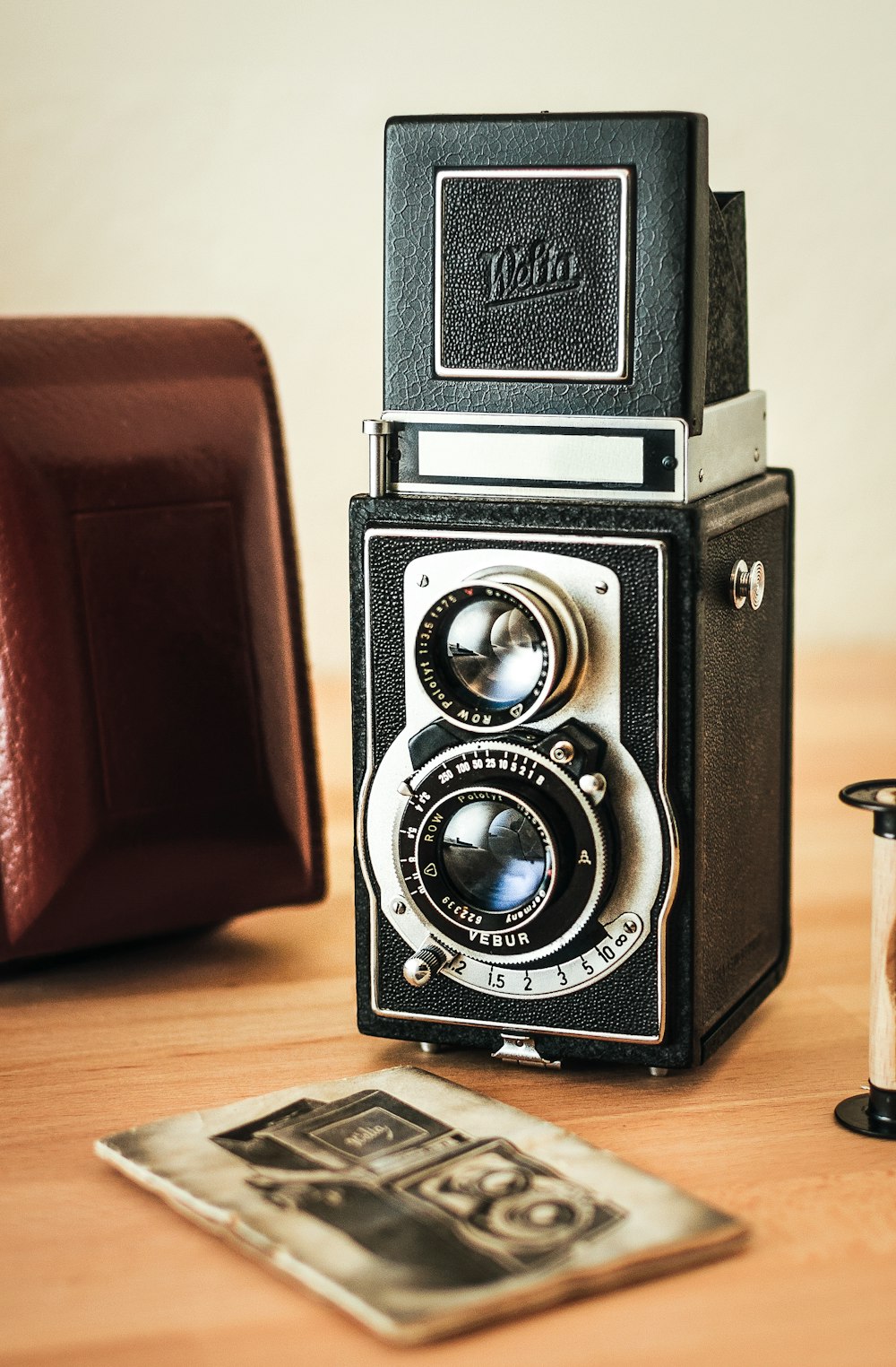 black and silver camera on brown wooden table