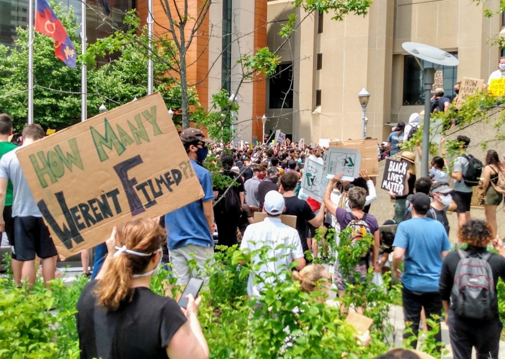 people standing near brown building during daytime