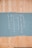 A painted section on a wooden board featuring vertically arranged words forming an acronym: LOOTING, with each letter starting a word. The words are written in white paint on a sky-blue background, contrasting with the natural wood color around it.