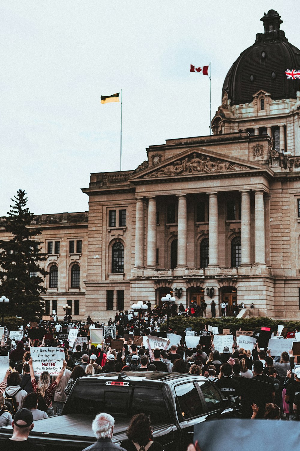 people in front of brown concrete building during daytime