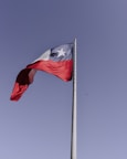 red and white flag on pole during daytime