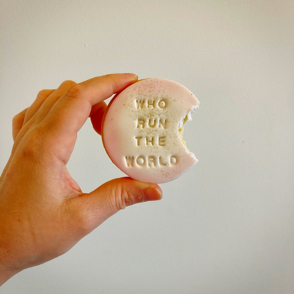 person holding white round ornament