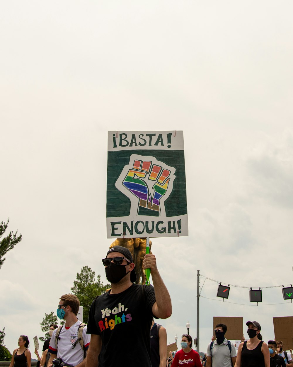 a man holding a sign that says ibasta enough