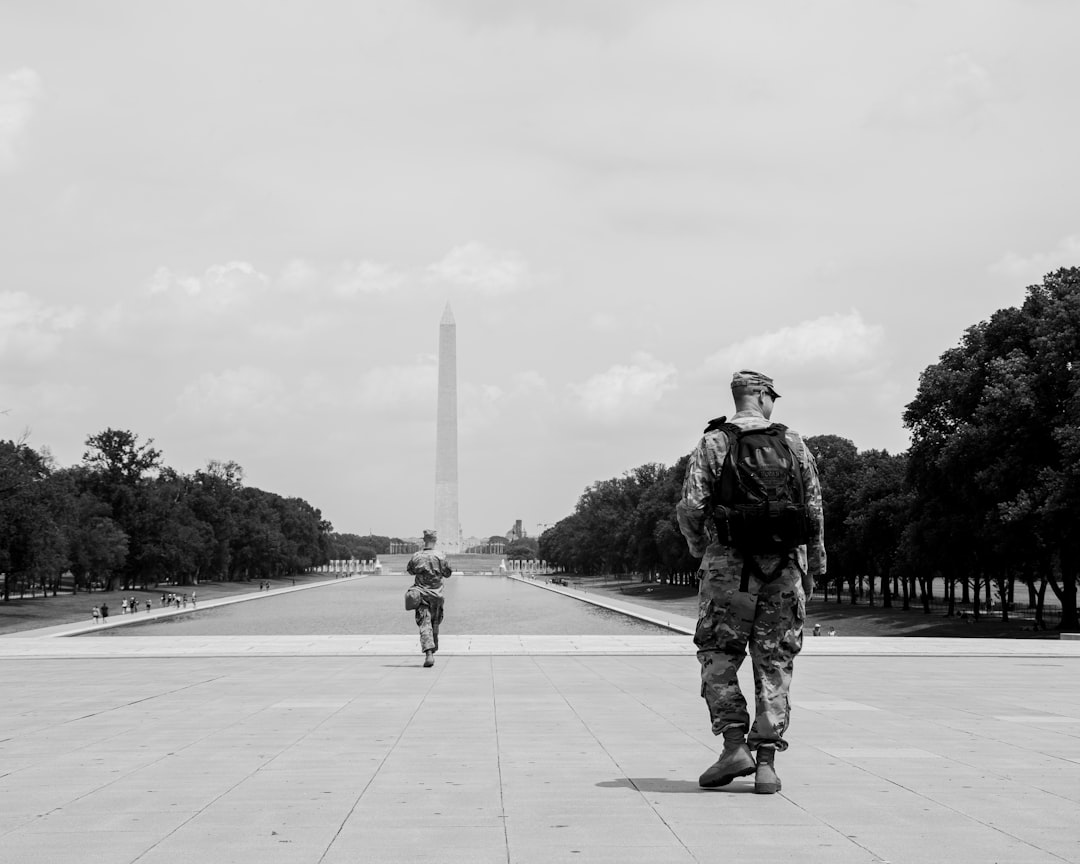 man in black jacket and pants walking on park, Black Lives Matter Protest in DC, 6/6/2020.<p></figure>(Instagram: @koshuphotography)