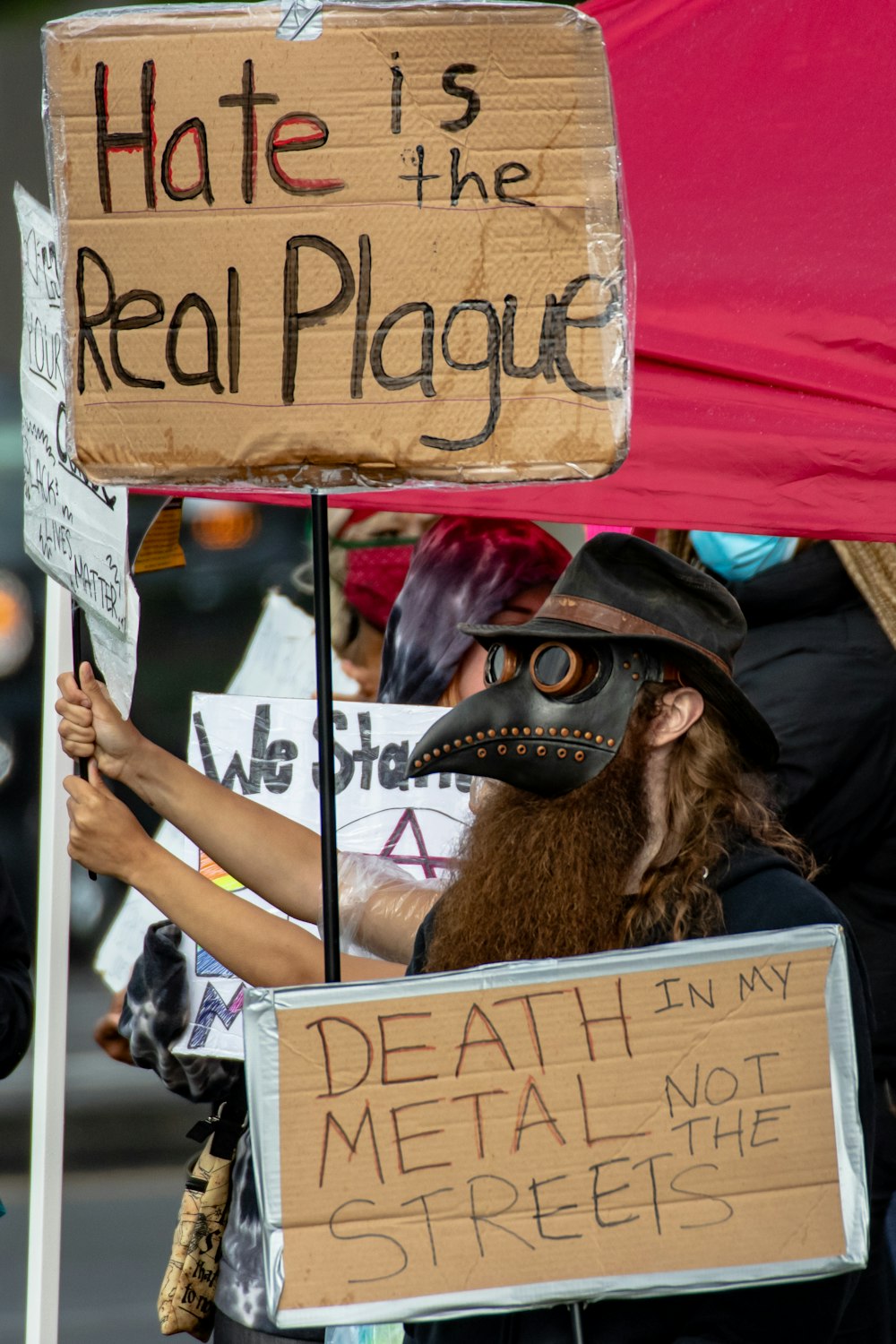 person holding brown wooden welcome signage