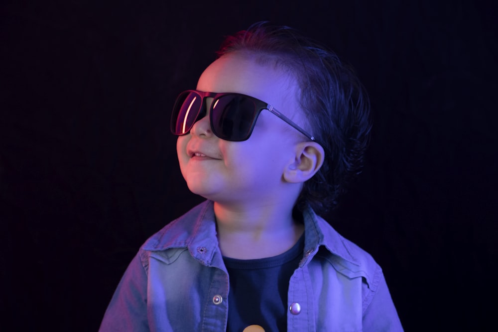 man in black sunglasses and blue button up shirt