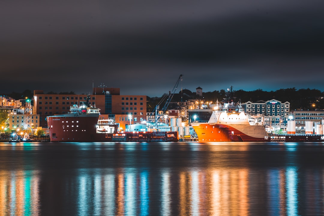 white and orange ship on dock during night time
