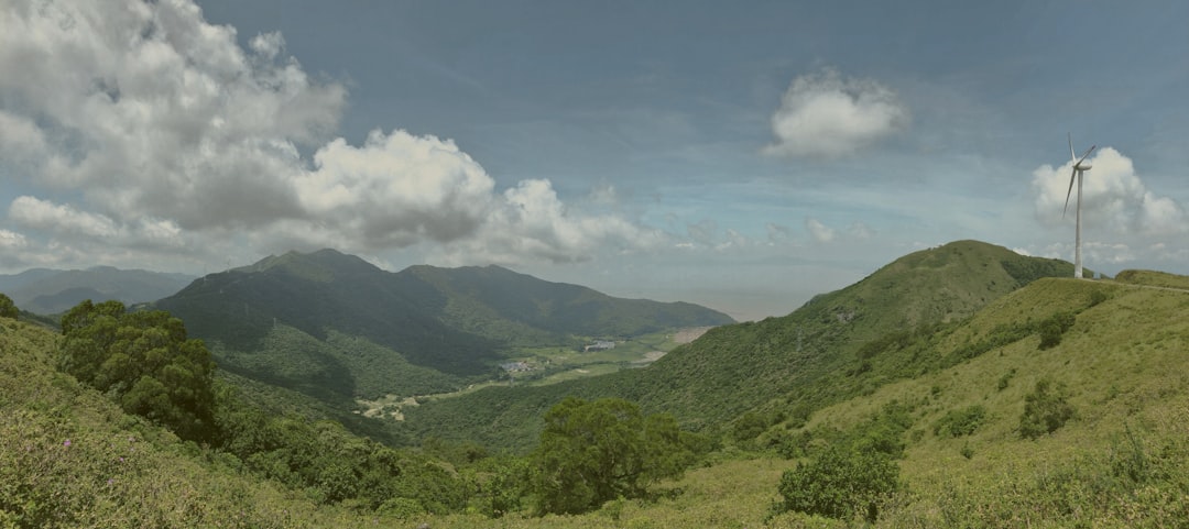 green mountains under white clouds and blue sky during daytime