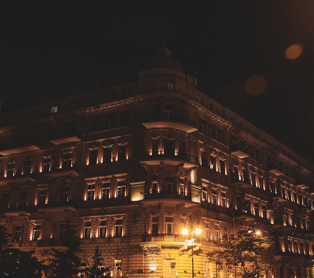 Historic boutique hotel facade with warm lighting in the evening