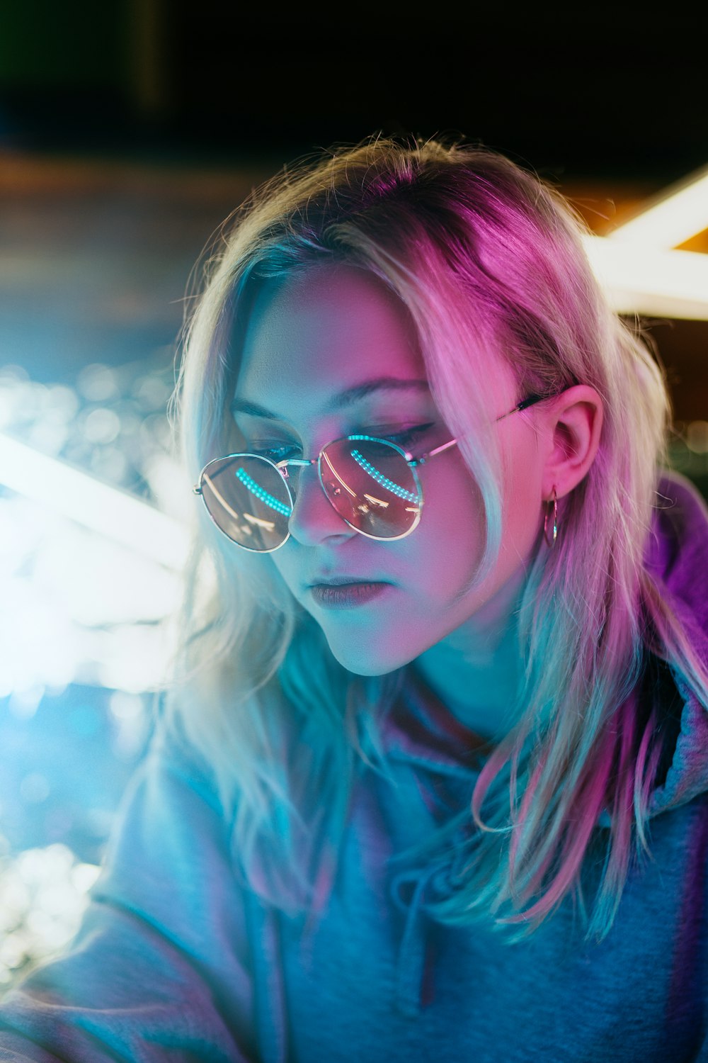 woman in blue shirt wearing silver framed eyeglasses