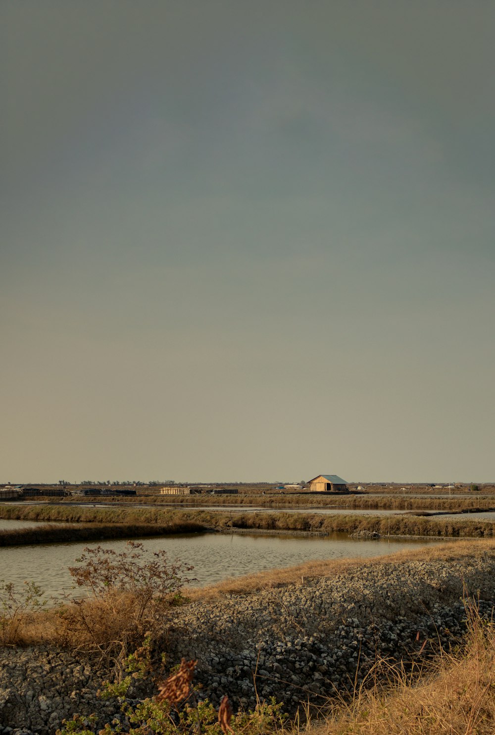 white and brown house near body of water during daytime