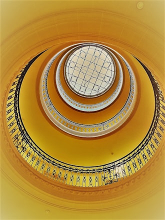 brown spiral staircase with white ceiling