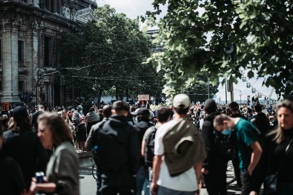 a large group of people walking down a street