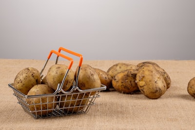 brown round fruit on gray metal rack potato teams background