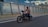 man in orange polo shirt riding black motorcycle