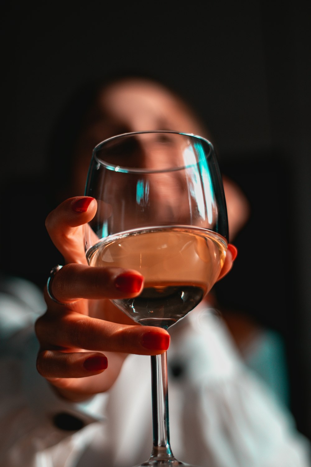 person holding clear wine glass