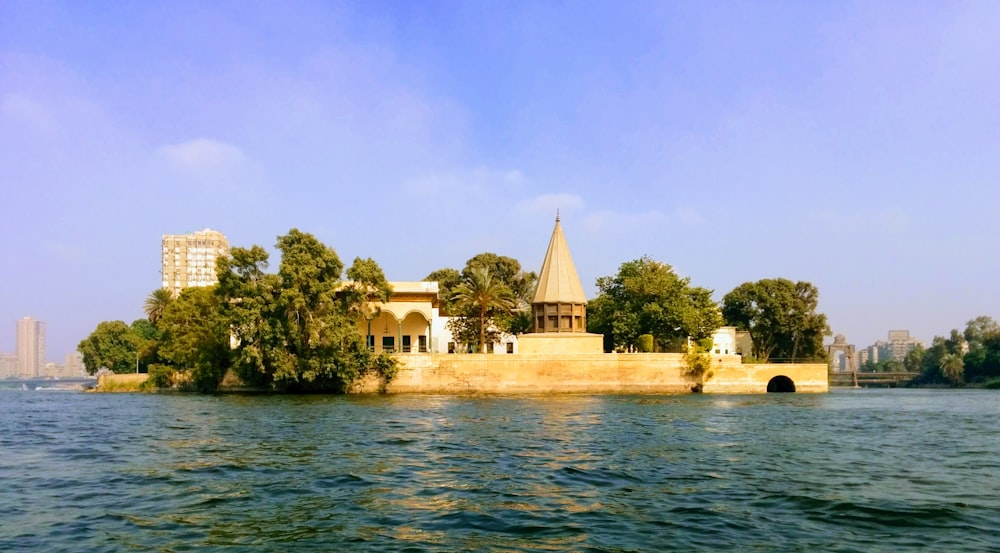 white concrete building near body of water during daytime