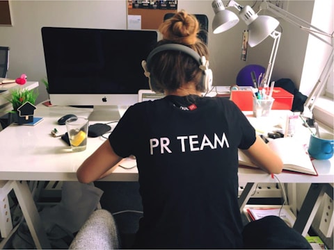 woman in black and white crew neck t-shirt sitting on black office rolling chair