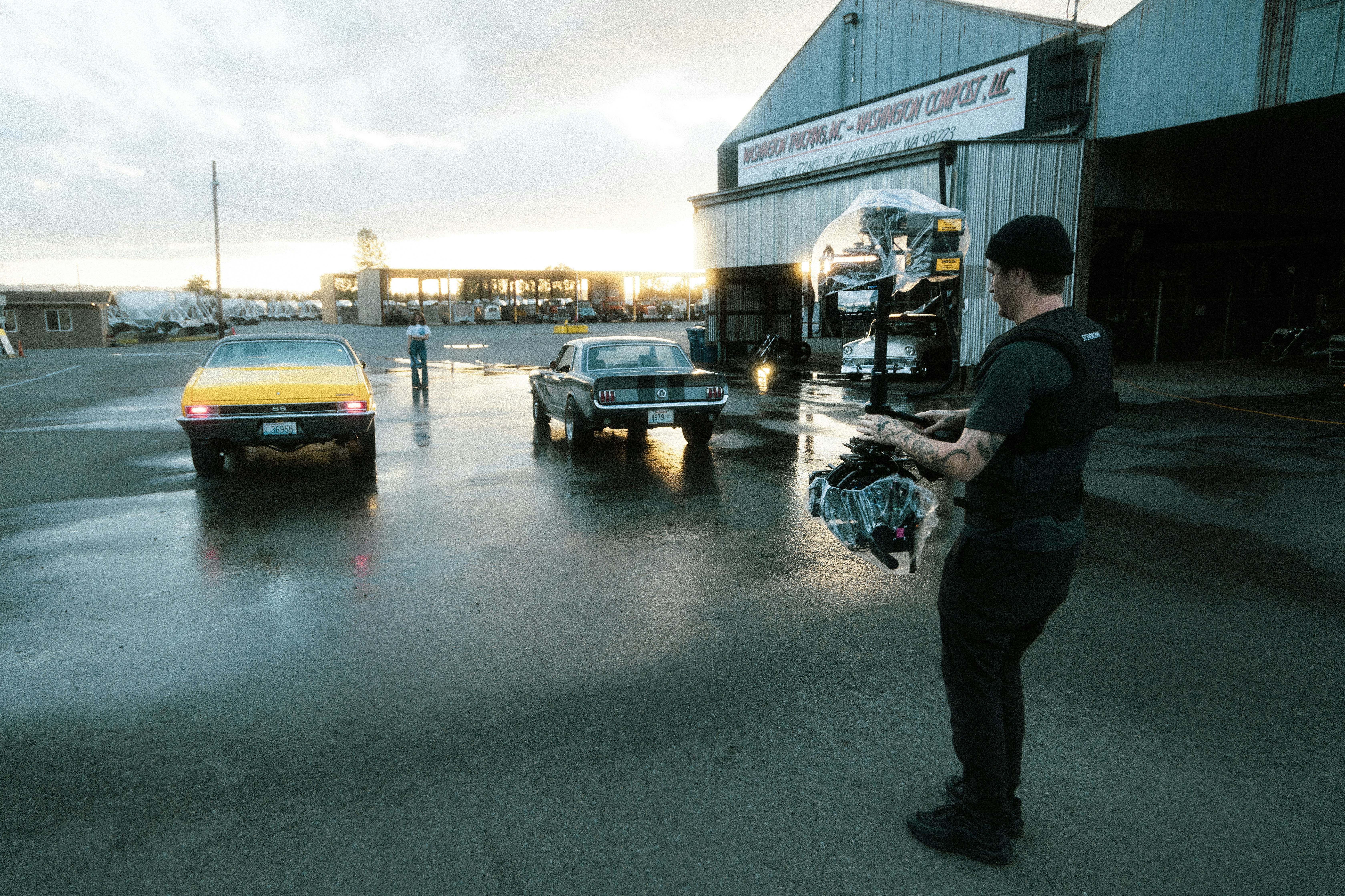 man in black jacket standing beside black car during daytime