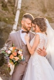 woman in white wedding dress holding bouquet of flowers