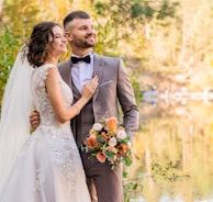 man in gray suit and woman in white wedding dress
