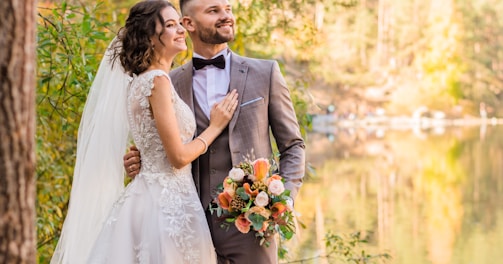 man in gray suit and woman in white wedding dress