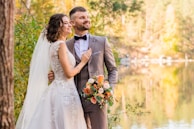 man in gray suit and woman in white wedding dress