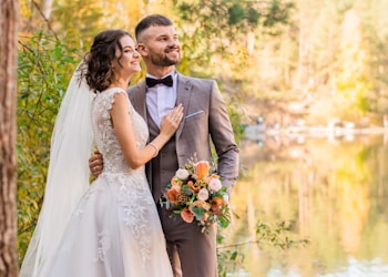 man in gray suit and woman in white wedding dress