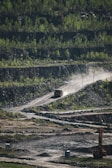 Trucks transporting minerals on a dirt road.