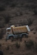 white and brown jeep wrangler on brown field during daytime