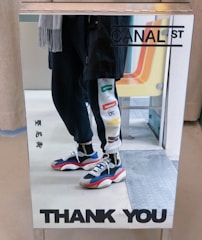 Happy customer trying on custom jeans in front of a mirror.