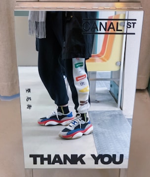 Happy customer trying on custom jeans in front of a mirror.