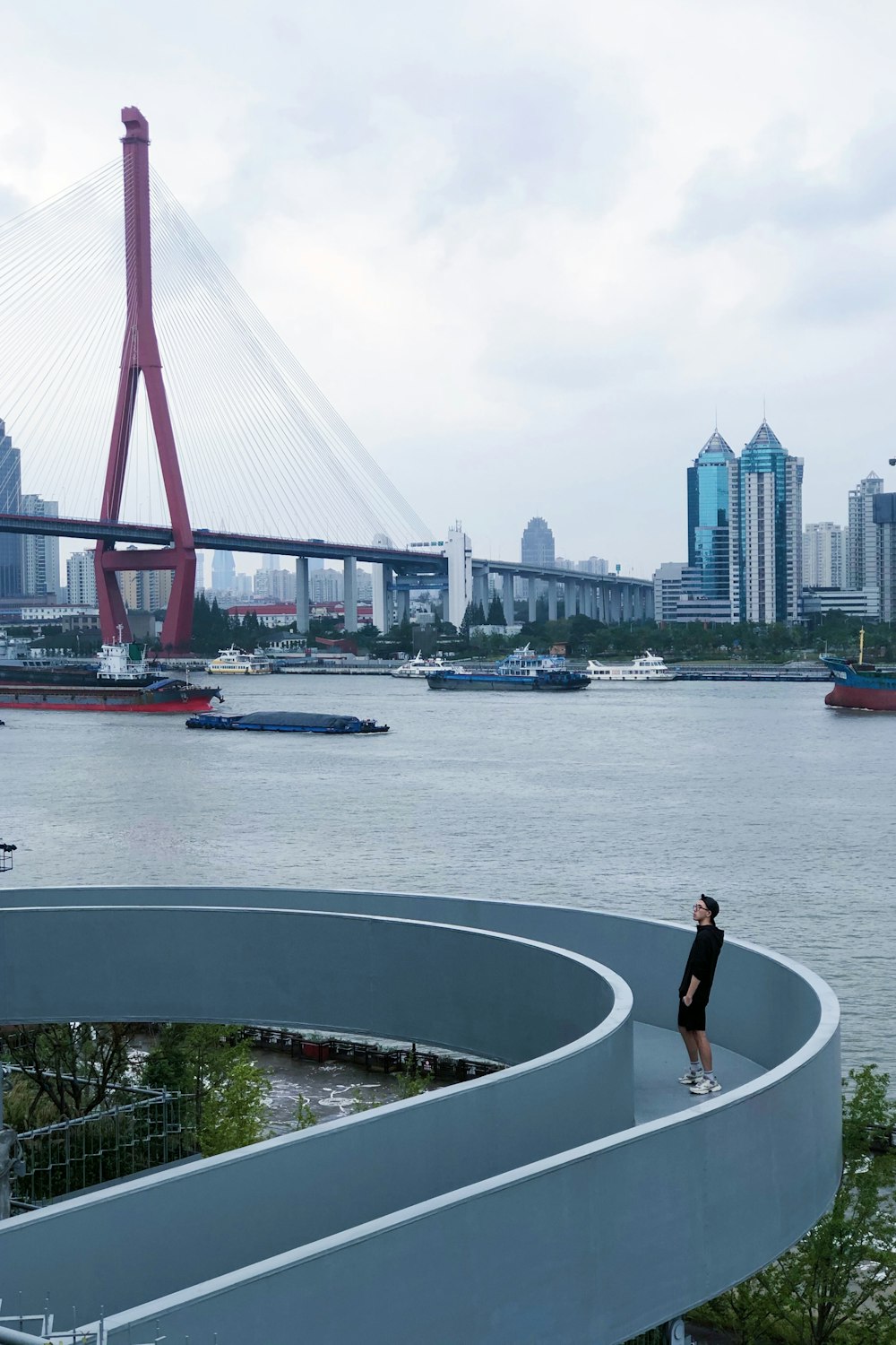 woman in black shirt standing on boat near bridge during daytime