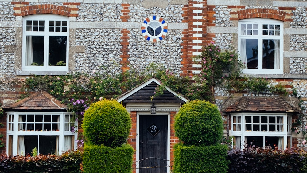 brown brick building with green plants