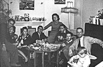 A diverse group of people watching TV together in a cozy living room.