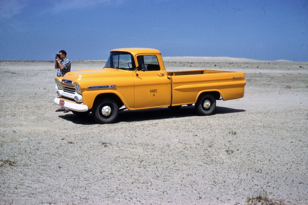 yellow chevrolet single cab pickup truck on gray concrete road during daytime