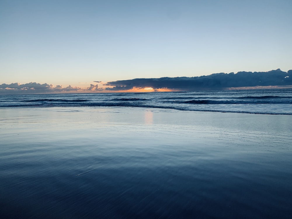 body of water during sunset