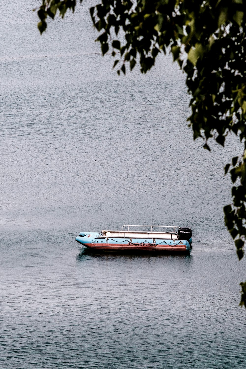 red and white boat on water