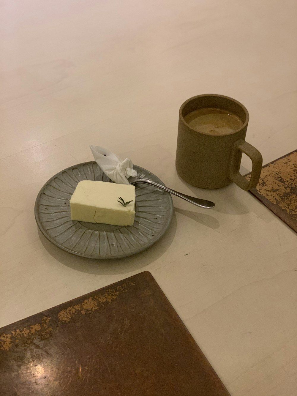 stainless steel fork beside white ceramic mug on brown wooden table