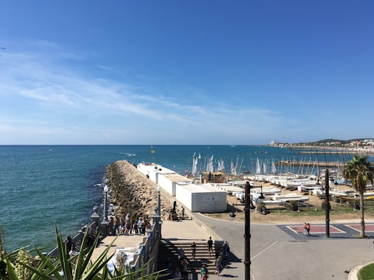 white and black boats on sea dock during daytime in Sitges Spain