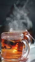 A close-up of herbal tea steaming in a cozy setting.