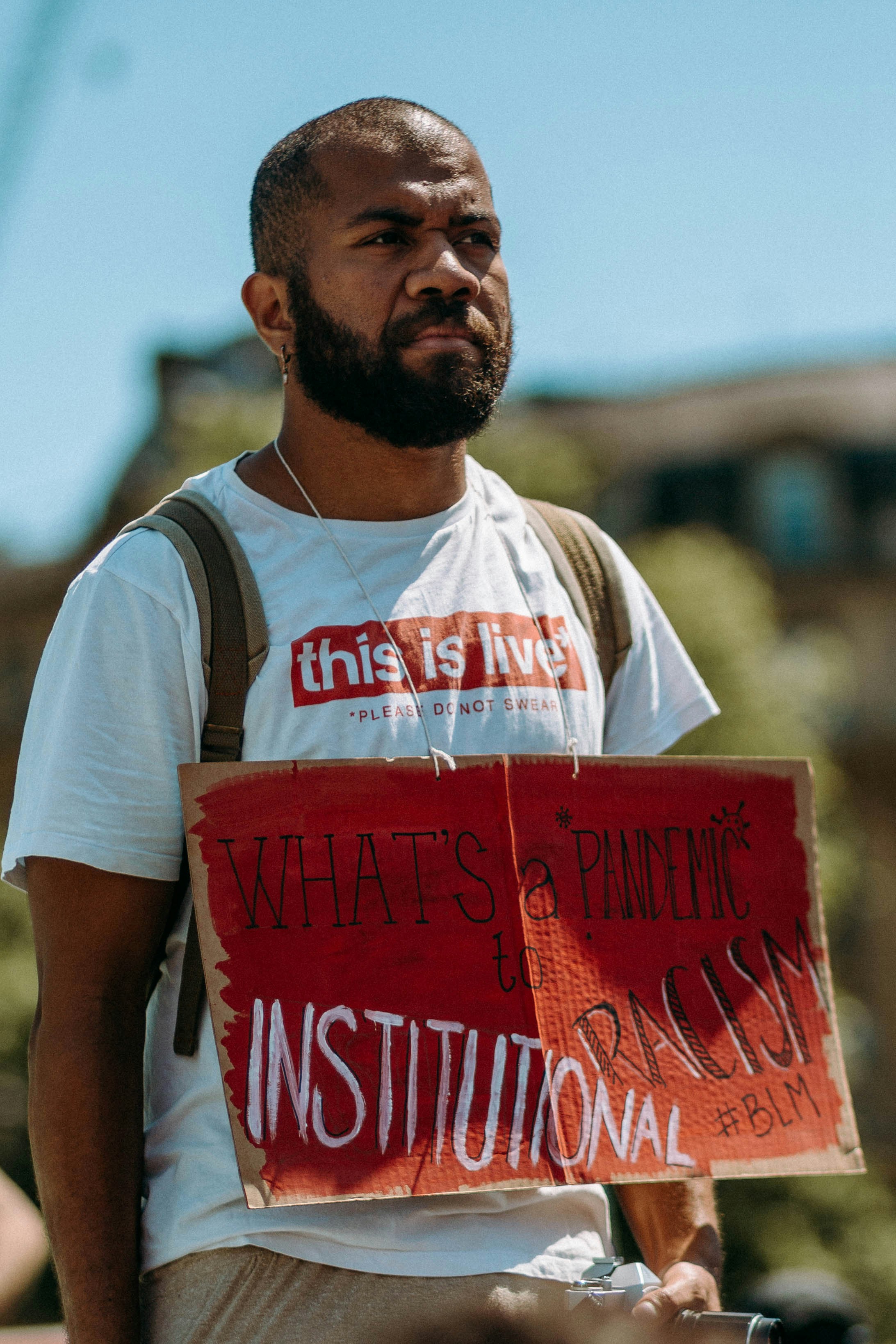 man in white and red crew neck t-shirt holding red box