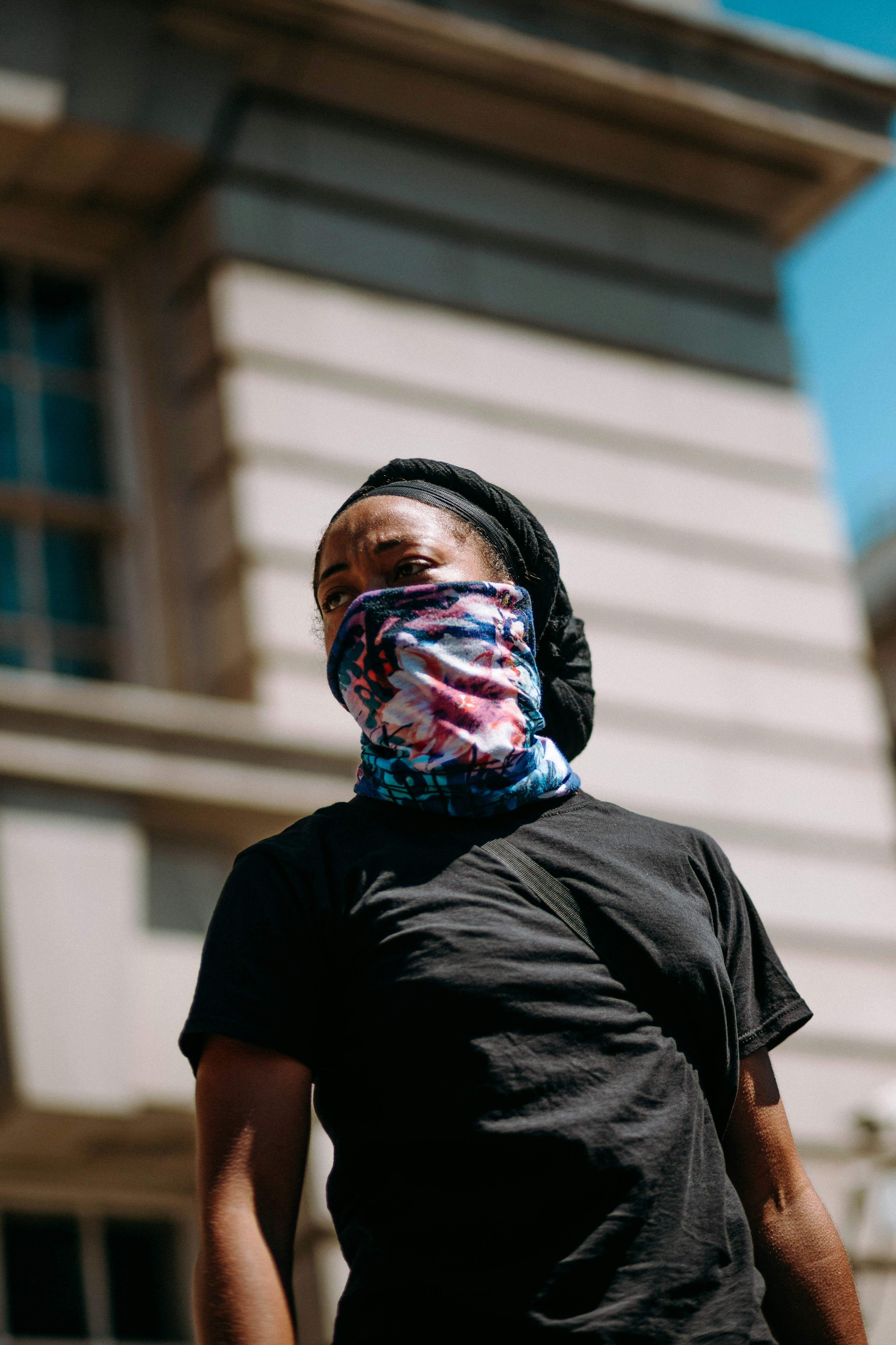 woman in black crew neck t-shirt with multi colored face paint