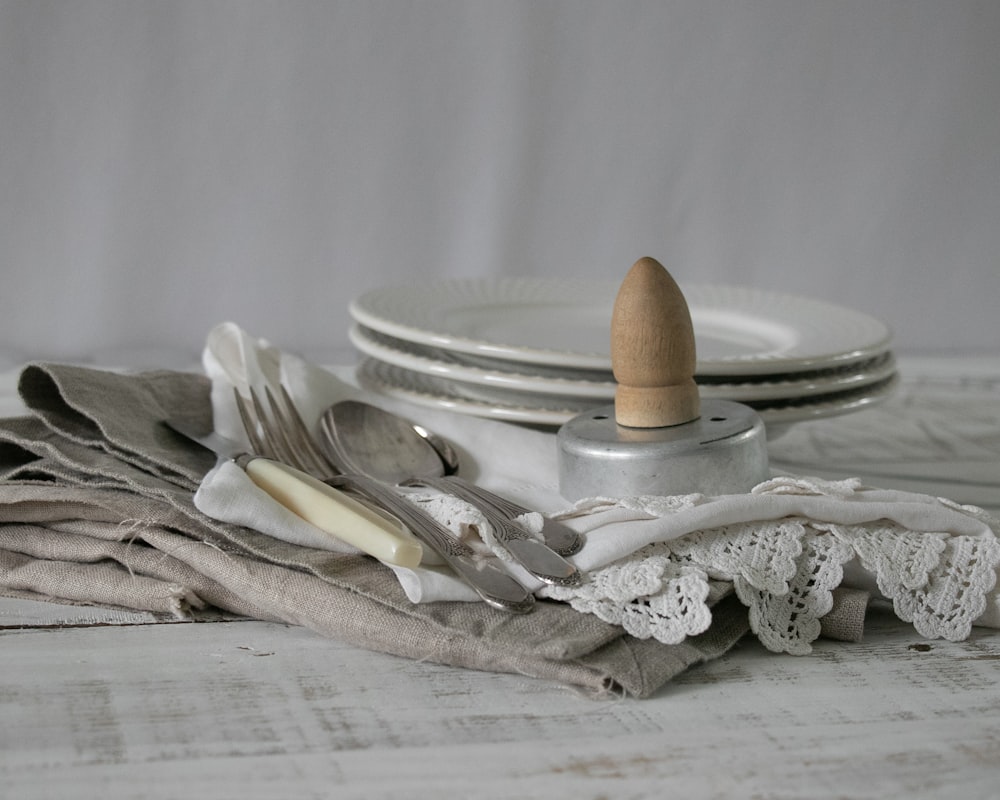 brown wooden spoon and fork on white textile