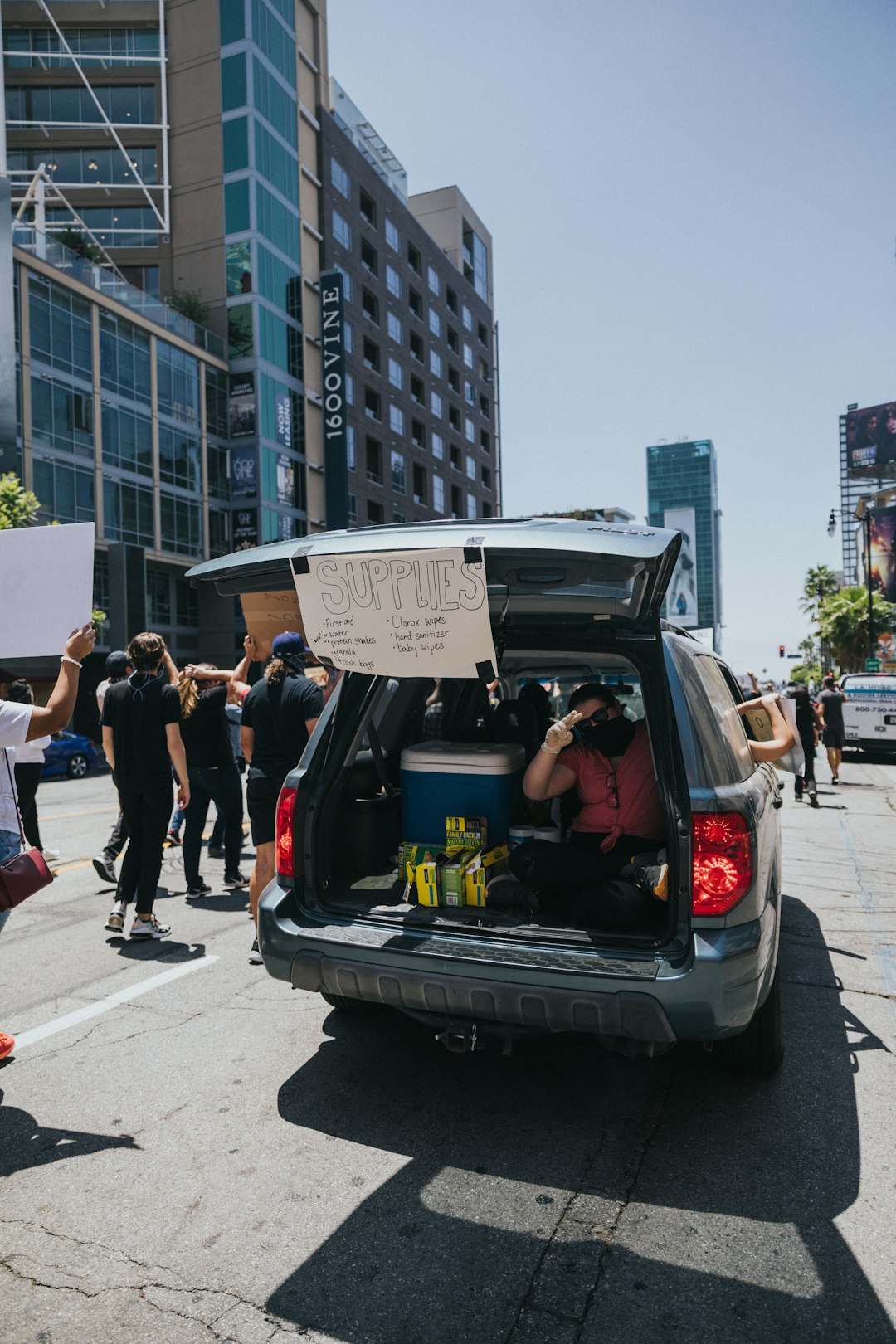 people standing beside black car during daytime