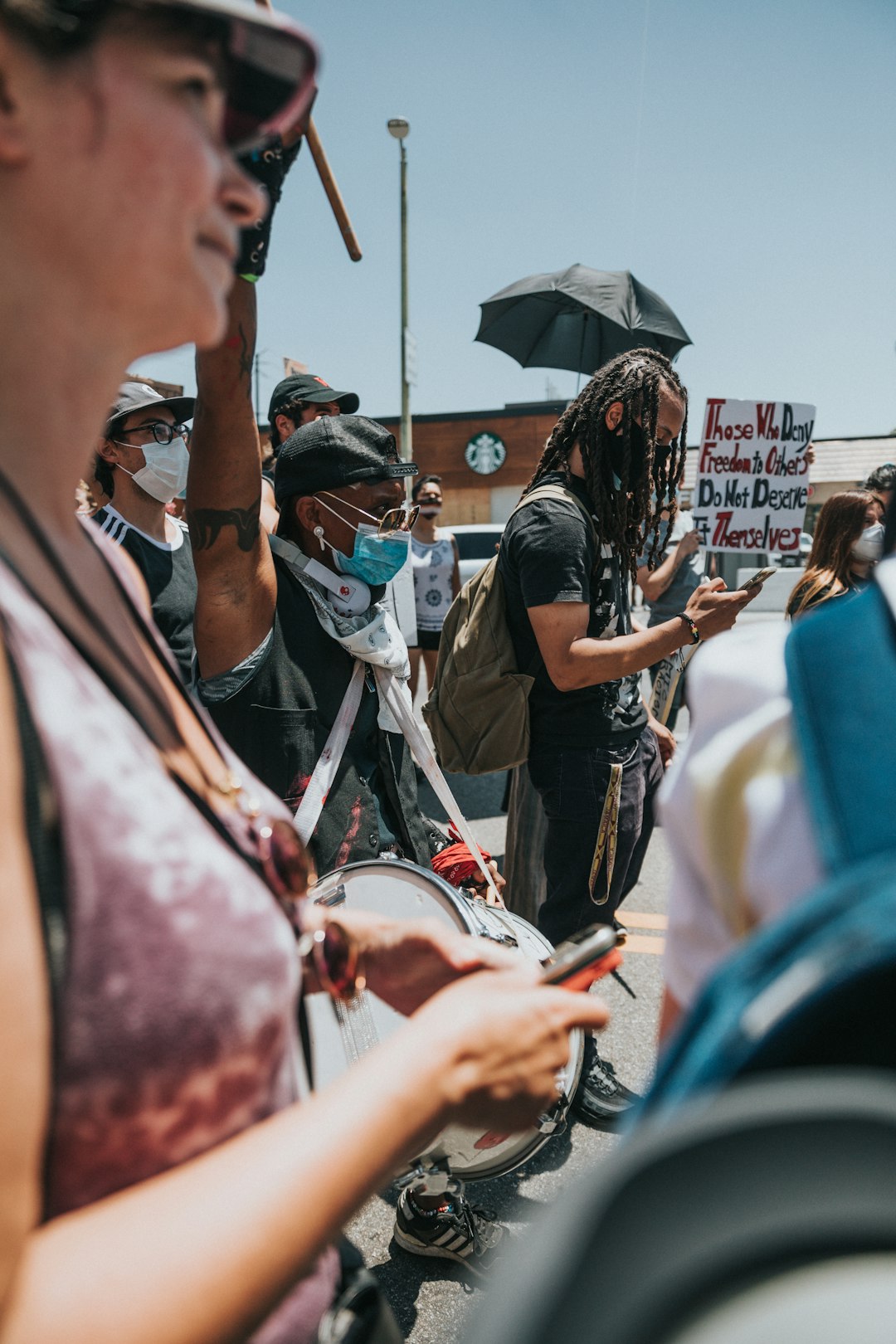 man in black t-shirt holding black umbrella during daytime